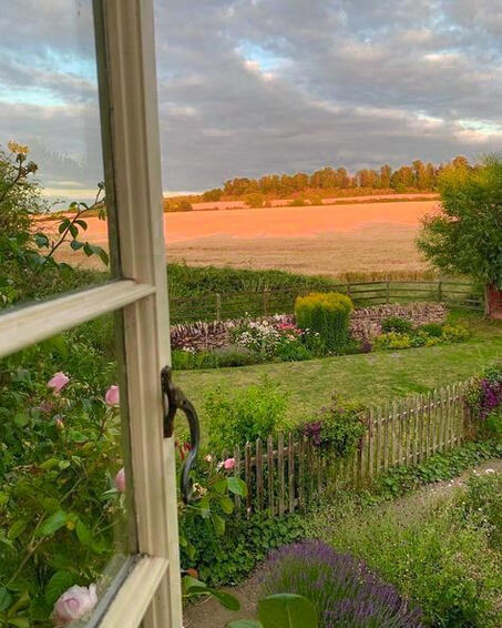 Open window overlooking a garden backing onto a meadow
